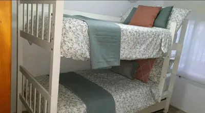 a bedroom with a bunk bed and a crib at Casa Pelicano in Chiclana de la Frontera
