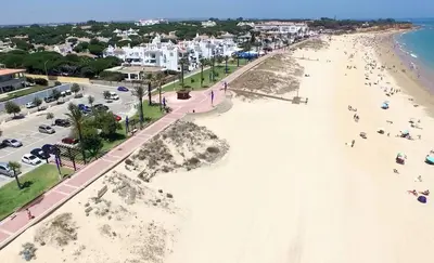 an aerial view of a beach with people and buildings at Villa Candari in Chiclana de la Frontera