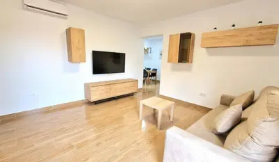 a living room with a couch and a flat screen tv at Villa Candari in Chiclana de la Frontera