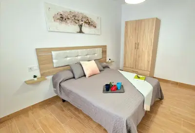 a bedroom with a bed with a tray on it at Villa Candari in Chiclana de la Frontera