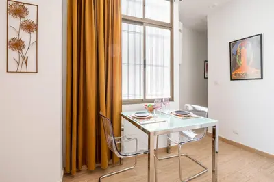a white table and chairs in a room with a window at Casa Dionisio - Súper central y tranquilo con terraza y parking in Jerez de la Frontera
