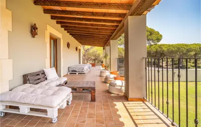 a patio with couches and a table and a fence at Gorgeous Home In Conil De La Frontera in Conil de la Frontera