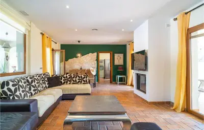 a living room with a couch and a fireplace at Gorgeous Home In Conil De La Frontera in Conil de la Frontera