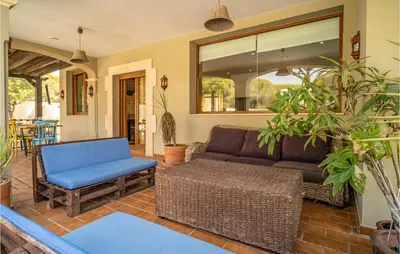 a living room with a couch and a chair at Gorgeous Home In Conil De La Frontera in Conil de la Frontera
