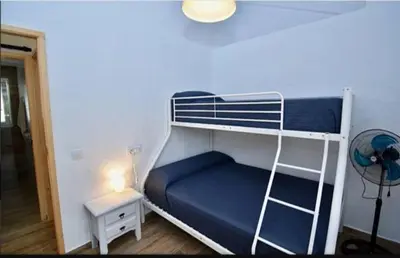 a bedroom with a bunk bed with a blue mattress at Casa Palmito in Chiclana de la Frontera