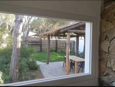 a window of a house with a picnic table outside at Casa Palmito in Chiclana de la Frontera