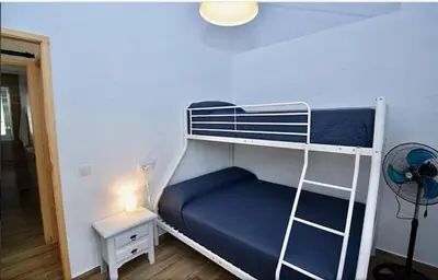 a bedroom with a bunk bed with a blue mattress at Casa Palmito 2 in Chiclana de la Frontera