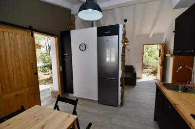 a kitchen with a refrigerator and a wooden table at Casa Palmito 2 in Chiclana de la Frontera