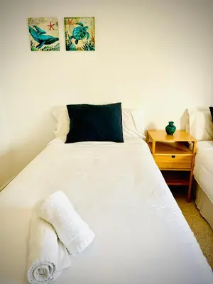 a bedroom with a white bed and a night stand at MyChoice America in Rota