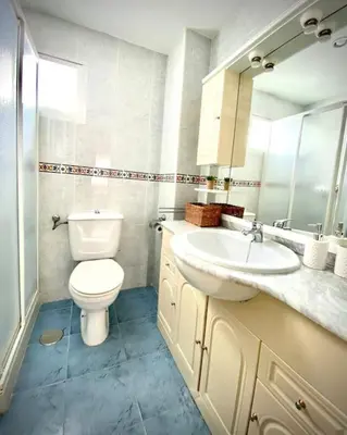 a white bathroom with a toilet and a sink at MyChoice America in Rota