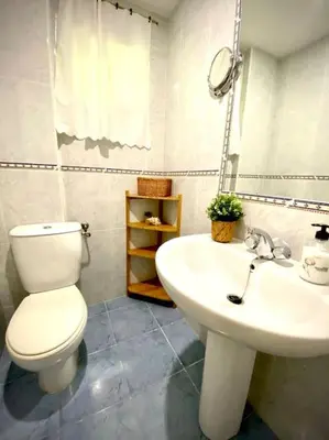 a bathroom with a white toilet and a sink at MyChoice America in Rota