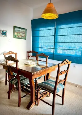 a dining room table with four chairs and a lamp at MyChoice America in Rota