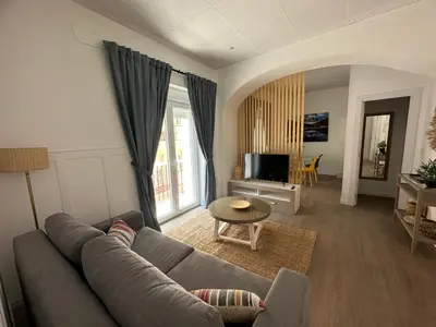 a living room with a couch and a table at Apartamento Nebro Sol, En el Corazón de Cádiz in Cádiz