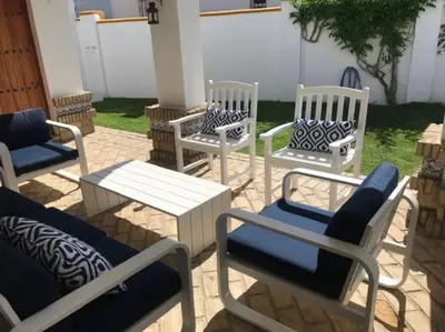 a group of chairs and tables on a patio at El Magnolio in Chiclana de la Frontera