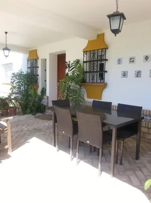a dining room with a table and chairs at El Magnolio in Chiclana de la Frontera