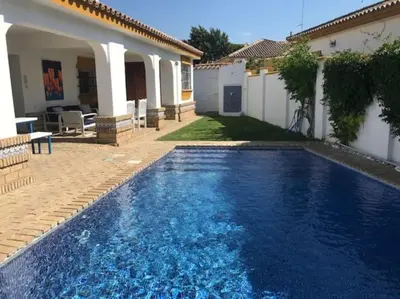 a swimming pool in the backyard of a house at El Magnolio in Chiclana de la Frontera