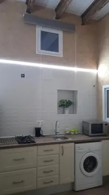 a kitchen with a sink and a washing machine at Apartamento Barrio Alto in Sanlúcar de Barrameda
