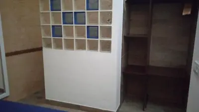 a bathroom with a white refrigerator with tiles on the wall at Apartamento Barrio Alto in Sanlúcar de Barrameda
