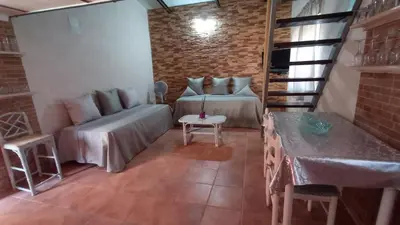 a living room with a couch and a table at La Casa de la Tranquilidad in El Puerto de Santa María