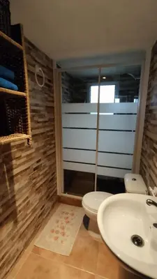 a bathroom with a toilet and a sink at La Casa de la Tranquilidad in El Puerto de Santa María
