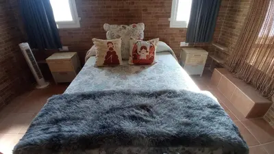a bedroom with a bed with a blue furry rug at La Casa de la Tranquilidad in El Puerto de Santa María