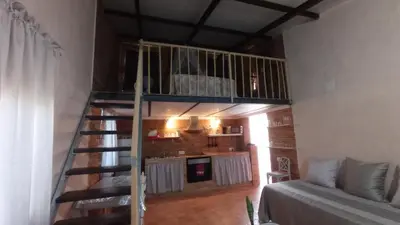 a room with a spiral staircase in a house at La Casa de la Tranquilidad in El Puerto de Santa María