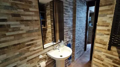 a bathroom with a sink and a mirror at La Casa de la Tranquilidad in El Puerto de Santa María