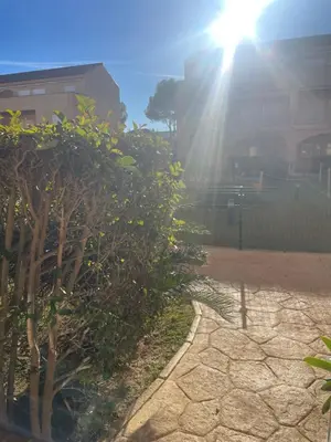 a sun shining behind some trees and a sidewalk at Novo Atlantico Golf 7 in Novo Sancti Petri