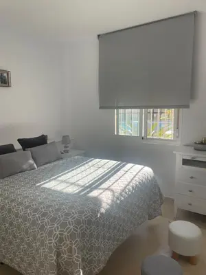 a white bedroom with a bed and a window at Novo Atlantico Golf 7 in Novo Sancti Petri