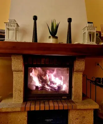a fireplace with a fire inside of it at Sunny Home pool & Garden in Arcos de la Frontera in Arcos de la Frontera