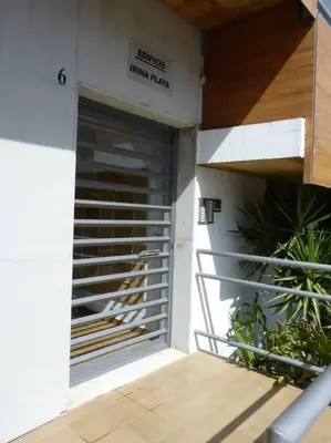 a entrance to a building with a metal garage door at Apartamento Irina Sol in Sanlúcar de Barrameda