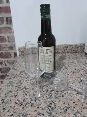 a wine glass sitting next to a bottle of wine at Apartamento Irina Sol in Sanlúcar de Barrameda