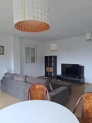 a living room with a couch and a tv at Apartamento Irina Sol in Sanlúcar de Barrameda