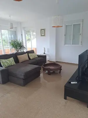 a living room with a couch and a coffee table at Apartamento Irina Sol in Sanlúcar de Barrameda