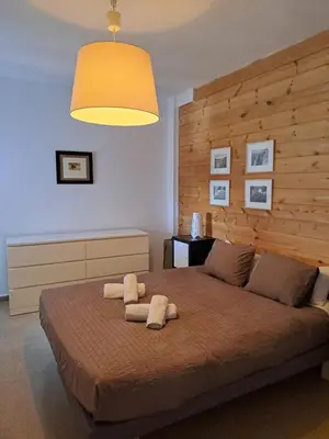 a bedroom with a large bed with two towels on it at Apartamento Irina Sol in Sanlúcar de Barrameda