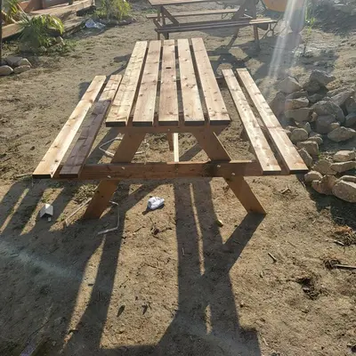 a wooden picnic table sitting on the ground at Boho Glamping en Complejo Rural el Mayorazgo in Cádiz