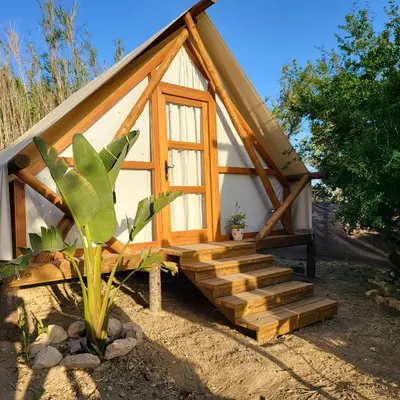 a small house with a staircase in front of it at Boho Glamping en Complejo Rural el Mayorazgo in Cádiz