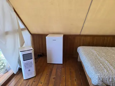 a room with a bed and a heater in a tent at Boho Glamping en Complejo Rural el Mayorazgo in Cádiz