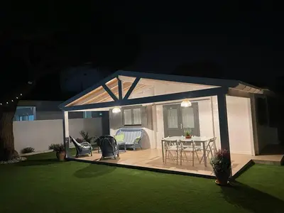 a gazebo with a table and chairs in a backyard at La casita del sopapo in Chiclana de la Frontera