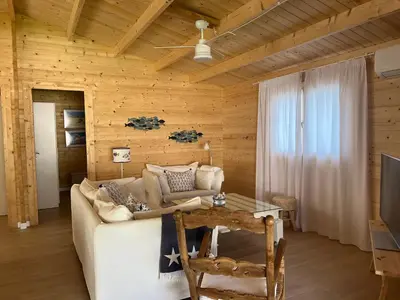 a living room with a white couch and a table at La casita del sopapo in Chiclana de la Frontera
