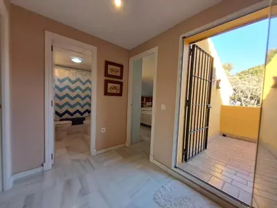 a hallway with a door leading to a bathroom at Casa playa El Ancla Puerto Santa María in El Puerto de Santa María