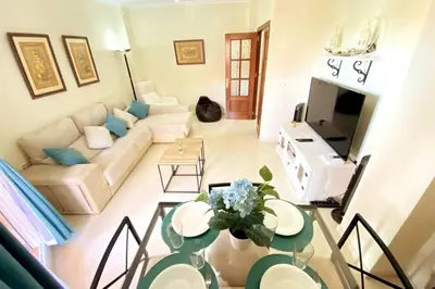 a living room with a couch and a table at Apartamento Camaleón in Chipiona