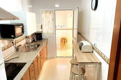 a kitchen with a sink and a counter top at Apartamento Camaleón in Chipiona