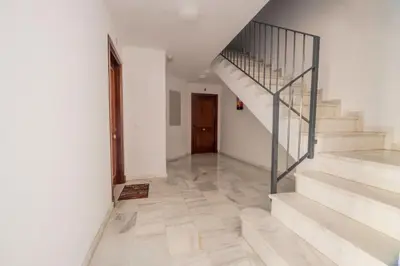 a hallway with stairs and a stair case at Lightbooking América I Sanlúcar de Barrameda in Sanlúcar de Barrameda