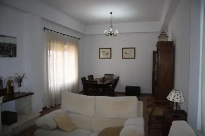 a living room with a white couch and a table at Moderno y amplio chalet, con piscina privada in Chiclana de la Frontera