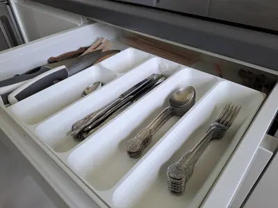 a drawer with silver utensils on a white tray at Apartamento Pinares del atlantico in Chiclana de la Frontera