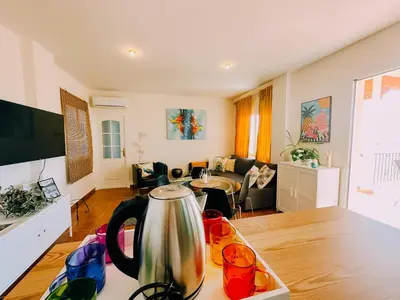 a kitchen and living room with a tea kettle on a table at DeCapi House in Sanlúcar de Barrameda
