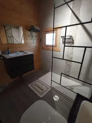 a bathroom with a toilet and a sink and a window at Casa de madera muy acogedora en una zona tranquila in Chiclana de la Frontera