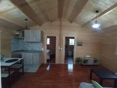a room with a kitchen and a living room at Casa de madera muy acogedora en una zona tranquila in Chiclana de la Frontera