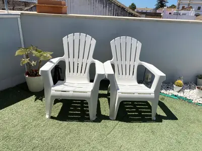 two white chairs sitting next to each other on a patio at LAS 7 ESQUINAS in El Puerto de Santa María